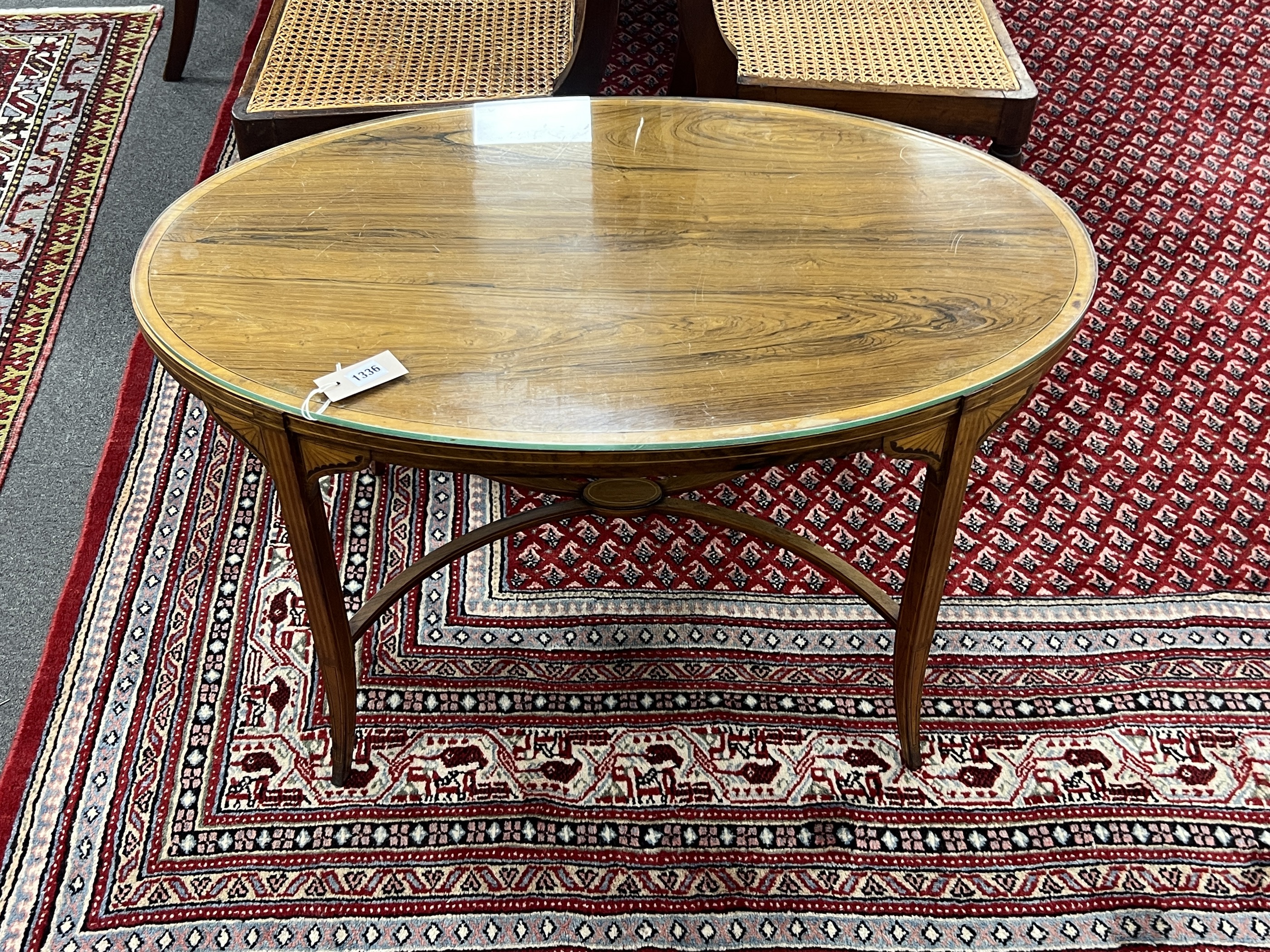 An Edwardian Schoolbred & Co. oval banded rosewood low occasional table converted from an etagere, width 88cm, depth 55cm, height 50cm